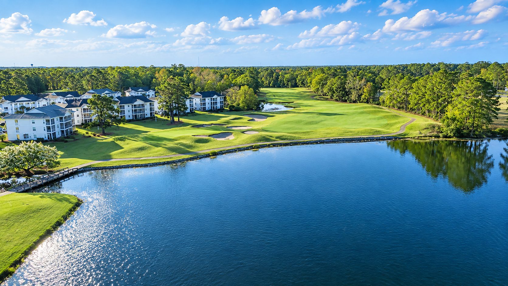 A golf course and lake with homes backing up to the fairway in Longs