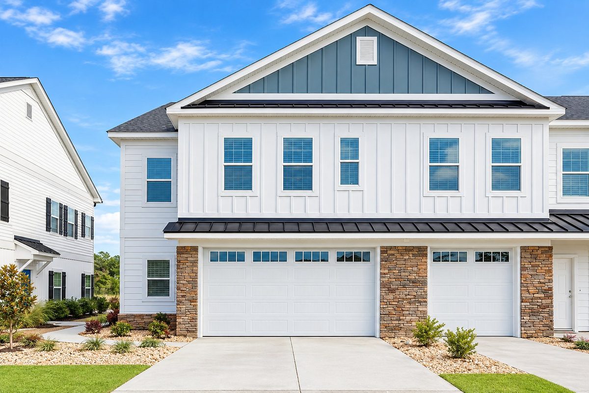 A two story townhome with a stone and board and batten front in Watertower Estates